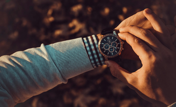 a person checking the time on his wrist watch