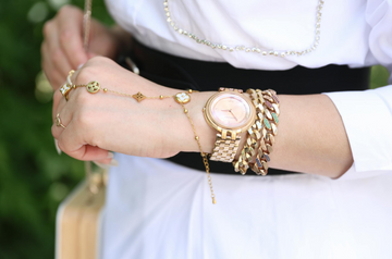 a woman wearing a wristwatch and jewelries