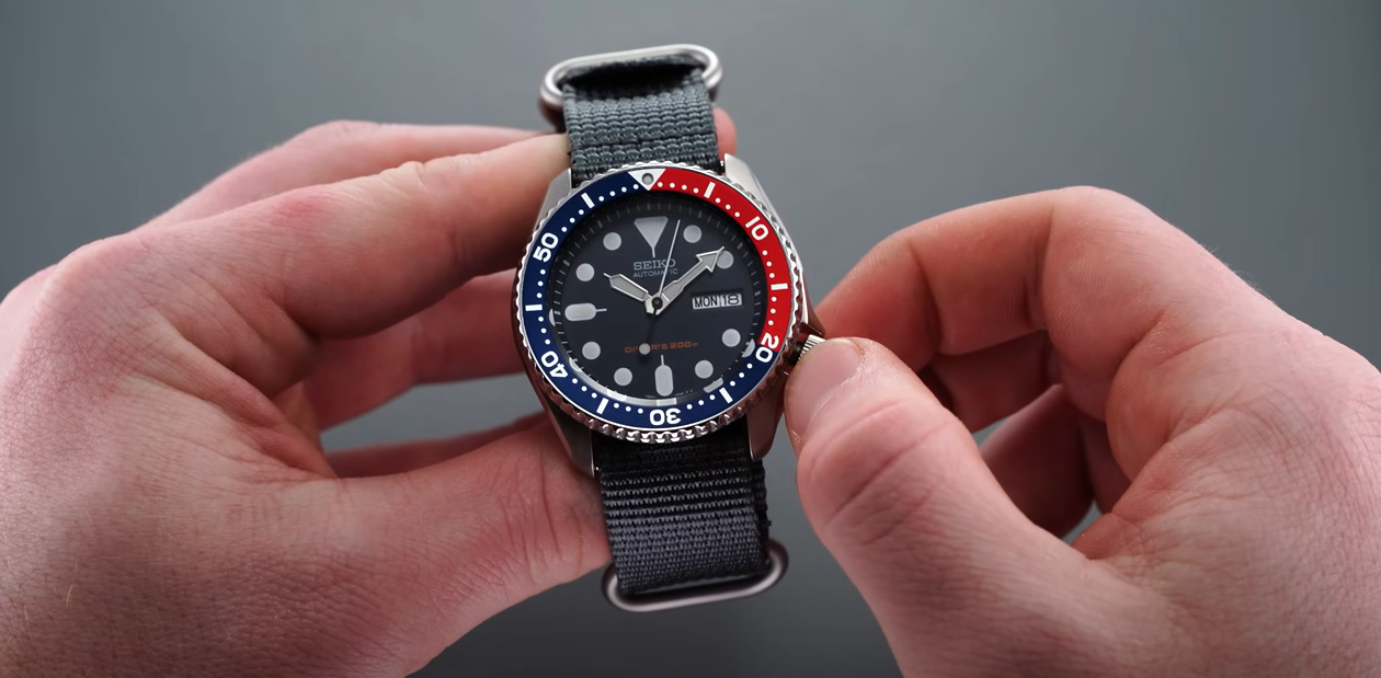 someone winding a Seiko watch
